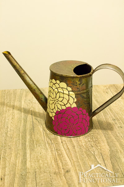 metal watering can decorated with yellow and purple flowers made with adhesive vinyl