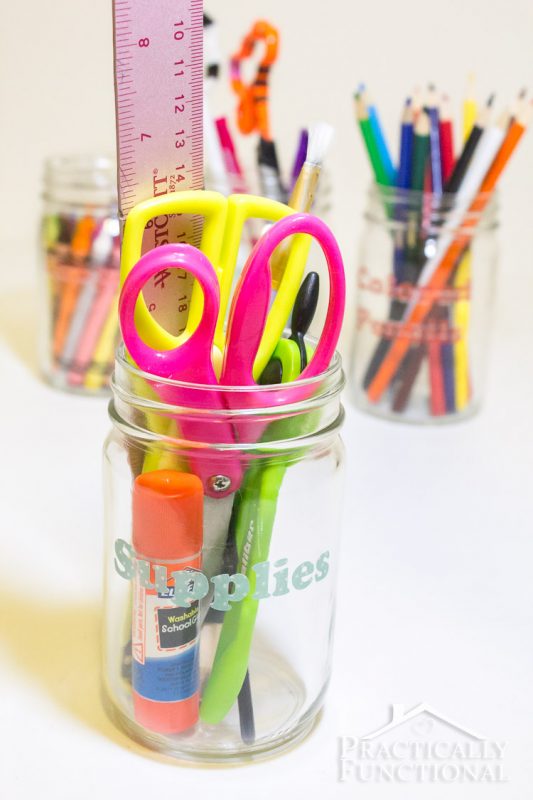 school supplies in clear mason jars organized with washi tape labels