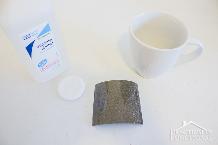plain white mug, heat transfer vinyl, and rubbing alcohol on a white table
