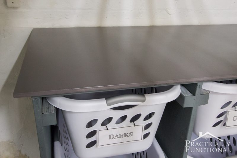 Simple DIY Laundry Basket Dresser stained and sealed top piece doubles as a folding and sorting station