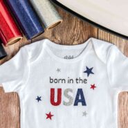 born in the usa baby onesie with cricut easypress and red, white, and blue glitter heat transfer vinyl
