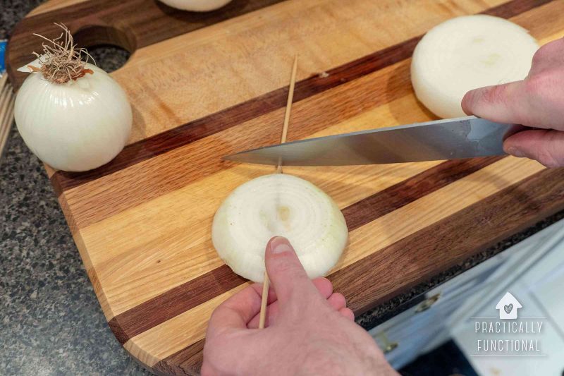 Wooden skewers help hold onion slices together while grilling