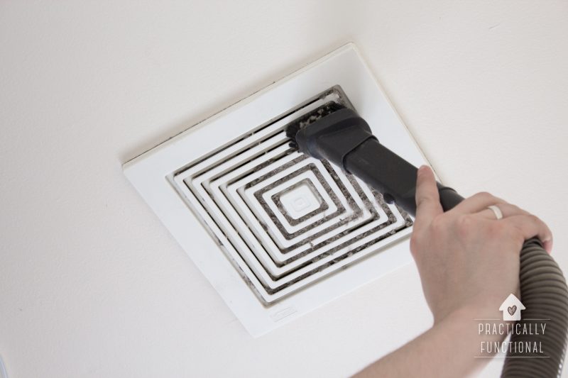 Clean a bathroom exhaust fan with a vacuum