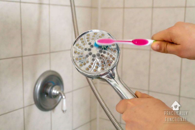 Deep clean your shower head with a toothbrush